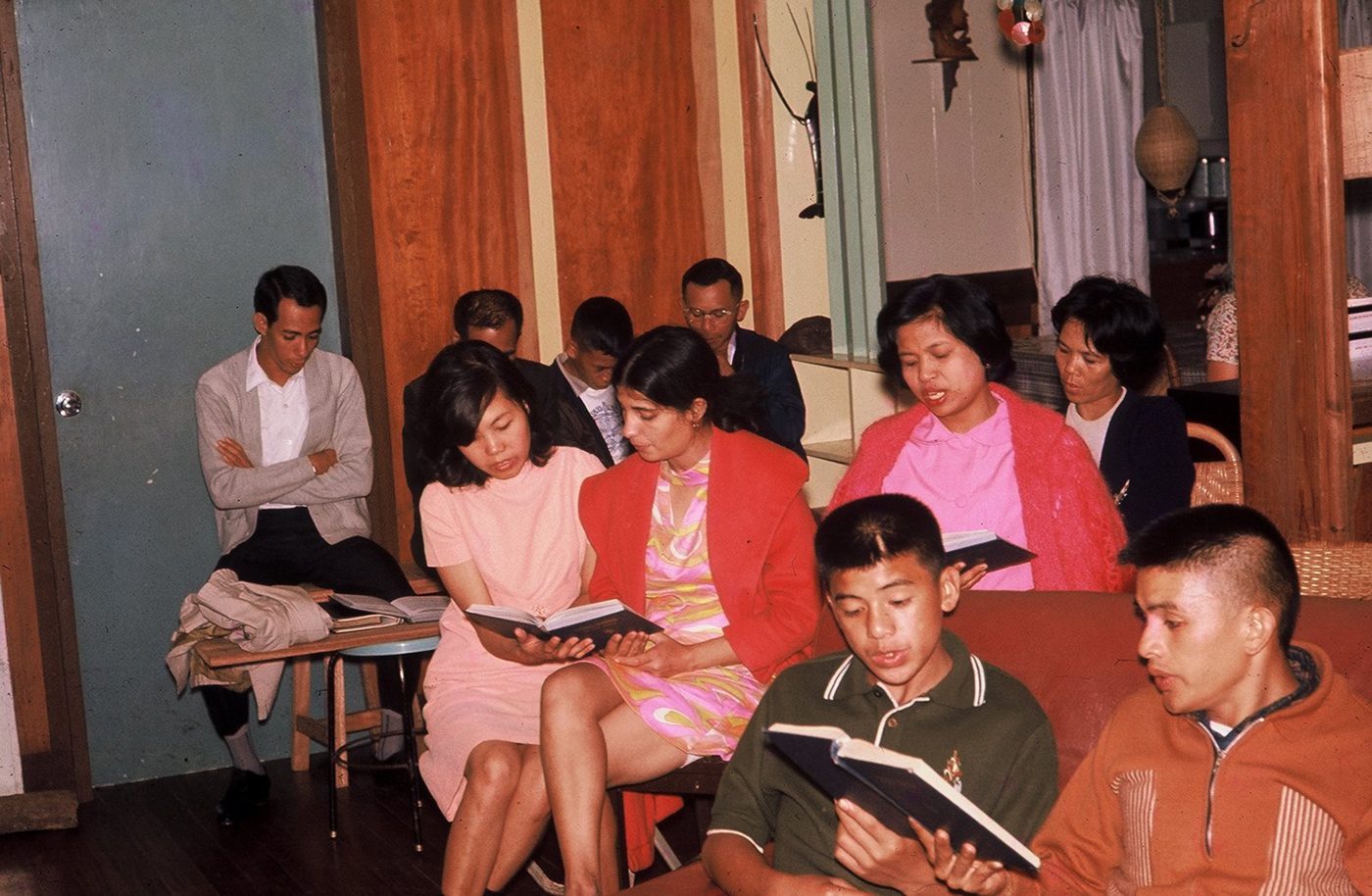 A singspiration at 55 Malvar. Evelyn is in the center. Rudy Ponce Deleon is sitting next to the door.