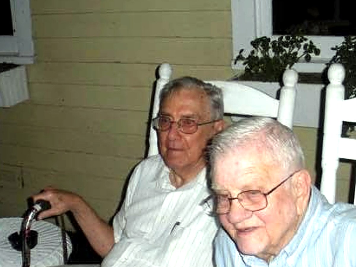 Ken Brooks and Ken Engle as old men, side by side in white rocking chairs on a porch, 2009